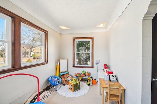 playroom featuring a wealth of natural light and a textured ceiling