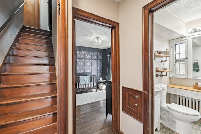 interior space featuring built in desk, a textured ceiling, and wood finished floors