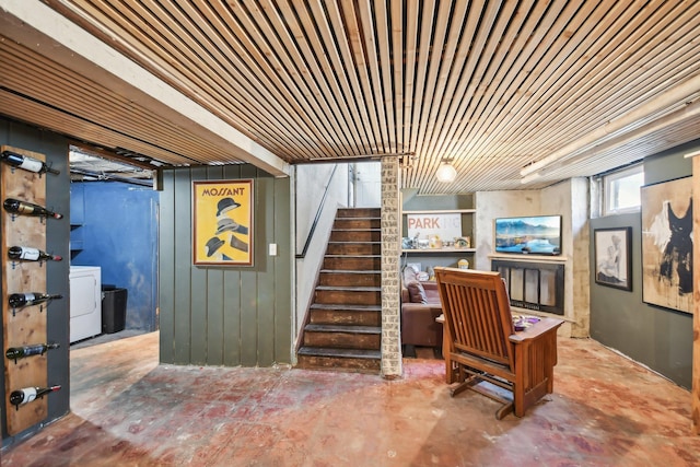 below grade area with stairway and washer / dryer