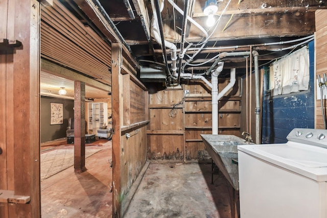 unfinished basement with washer / clothes dryer