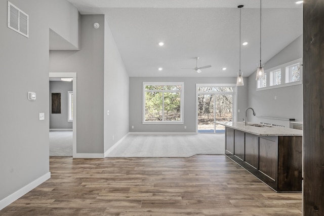 26284 1st St W, Zimmerman, MN 55398 - kitchen featuring visible vents, plenty of natural light, a sink, ceiling fan, and dark brown cabinetry