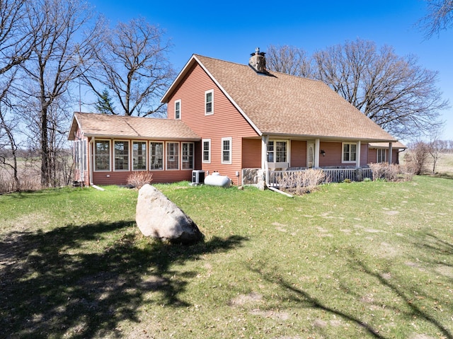 20437 County Highway 65, Henning, MN 56551 - rear view of property with a chimney, central AC, a sunroom, covered porch, and a yard