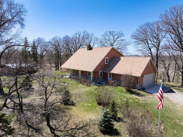 20437 County Highway 65, Henning, MN 56551 - view of home's exterior with concrete driveway, a chimney, covered porch, a shingled roof, and an attached garage
