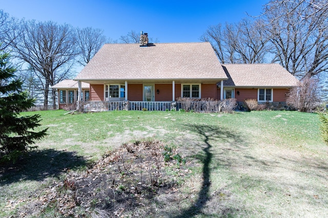 20437 County Highway 65, Henning, MN 56551 - view of front of property with a chimney, covered porch, a front yard, and roof with shingles