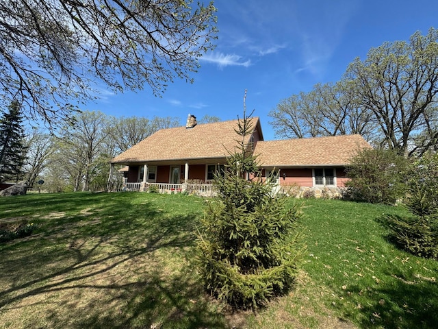 20437 County Highway 65, Henning, MN 56551 - rear view of property featuring a chimney, a yard, and a porch