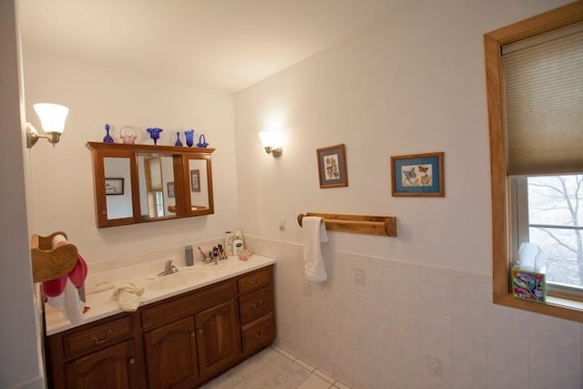 20437 County Highway 65, Henning, MN 56551 - bathroom with vanity, a wainscoted wall, tile patterned flooring, and tile walls