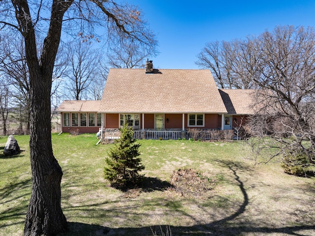 20437 County Highway 65, Henning, MN 56551 - view of front of property featuring a chimney, a front yard, a shingled roof, and a porch