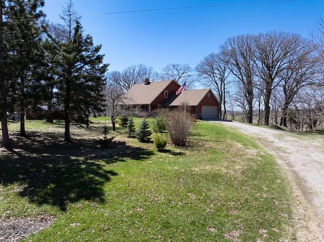 20437 County Highway 65, Henning, MN 56551 - view of side of home featuring dirt driveway, a chimney, a garage, and a yard