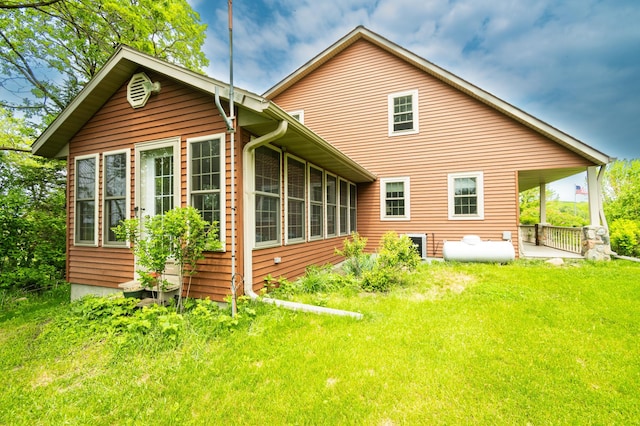 20437 County Highway 65, Henning, MN 56551 - back of property with a sunroom, a yard, and a patio area