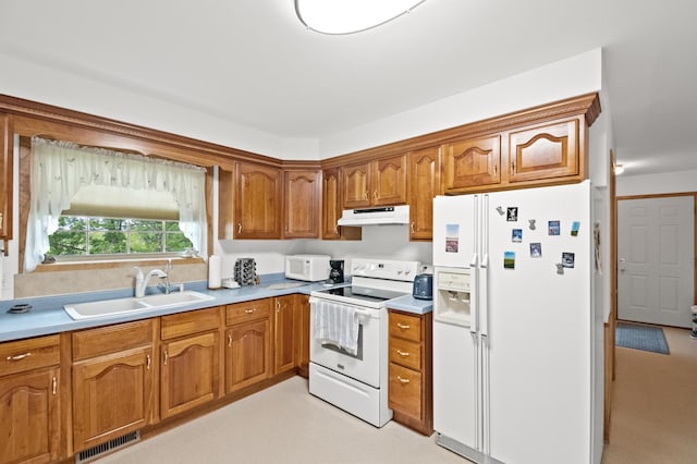 20437 County Highway 65, Henning, MN 56551 - kitchen featuring white appliances, under cabinet range hood, a sink, brown cabinets, and light countertops
