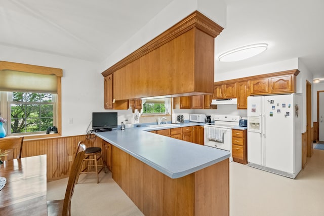 20437 County Highway 65, Henning, MN 56551 - kitchen with white appliances, under cabinet range hood, a peninsula, a sink, and brown cabinetry
