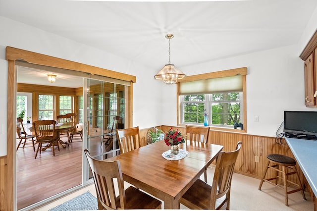 20437 County Highway 65, Henning, MN 56551 - dining room featuring a wainscoted wall, plenty of natural light, wood walls, and a chandelier