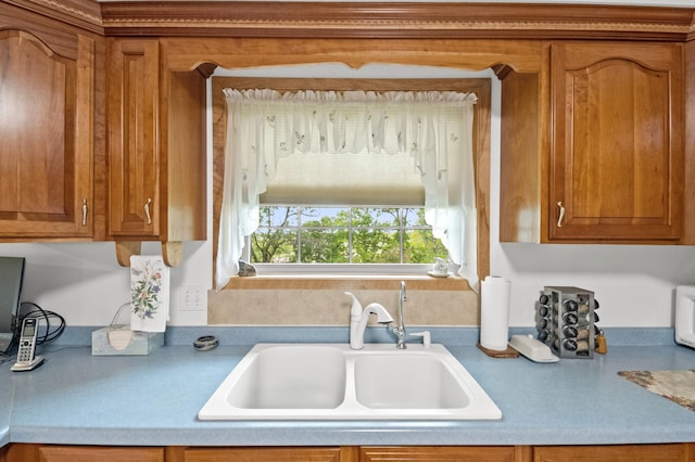 20437 County Highway 65, Henning, MN 56551 - kitchen with a sink, brown cabinetry, and light countertops