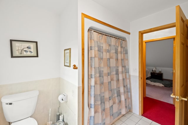 20437 County Highway 65, Henning, MN 56551 - bathroom featuring tile patterned floors, tile walls, toilet, wainscoting, and curtained shower