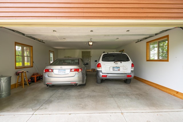 20437 County Highway 65, Henning, MN 56551 - garage featuring baseboards and a garage door opener