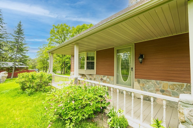 20437 County Highway 65, Henning, MN 56551 - property entrance with stone siding, a porch, and a yard