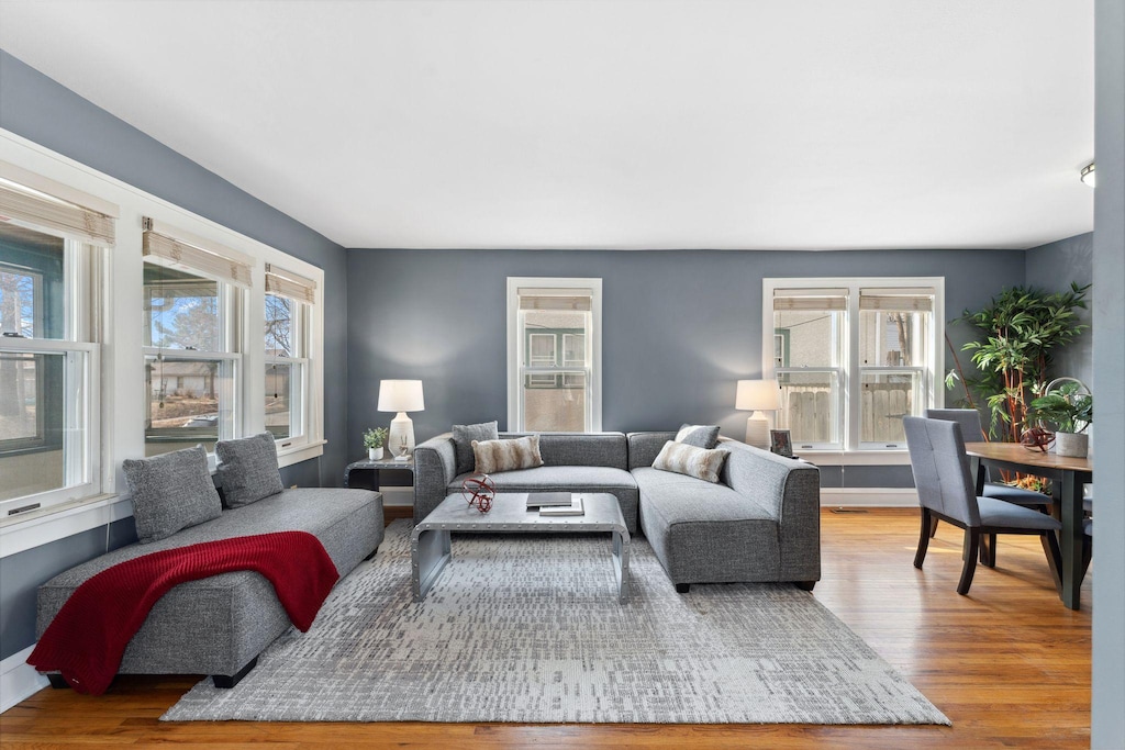 living room with baseboards and wood finished floors