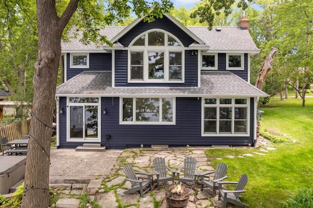 3035 Lakeshore Ave, Medina, MN 55359 - rear view of house with an outdoor fire pit, a patio area, a shingled roof, and a yard