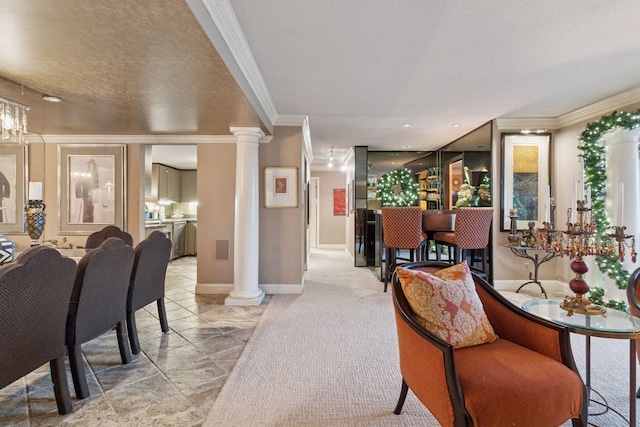 living area with ornate columns, crown molding, baseboards, and light marble finish flooring
