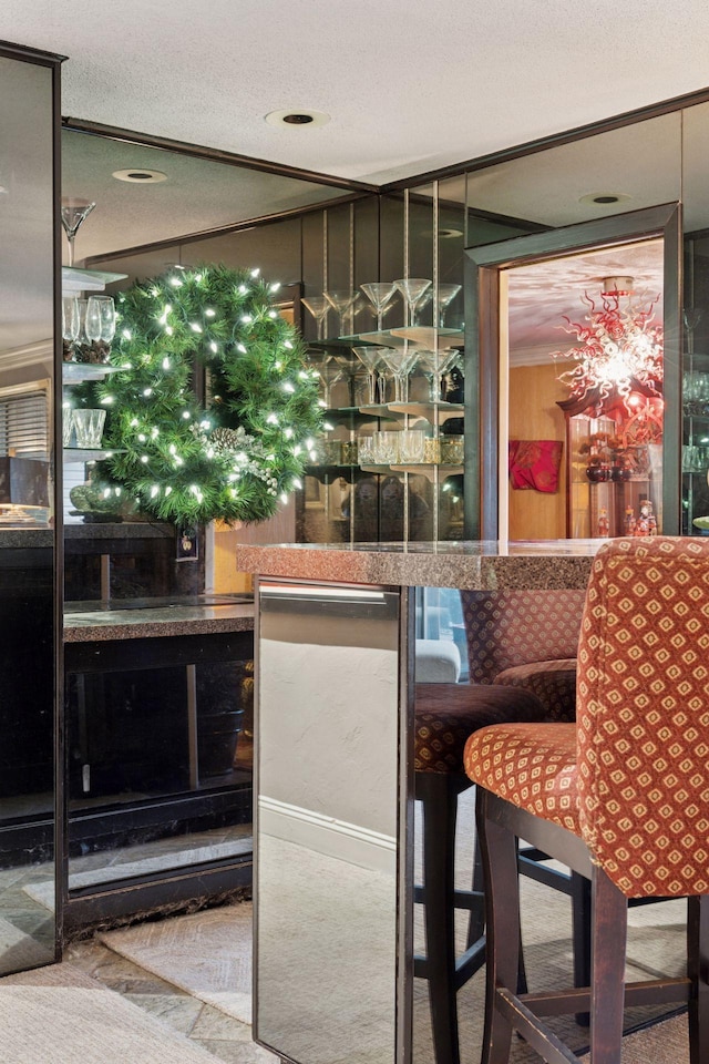 indoor dry bar featuring a textured ceiling and carpet