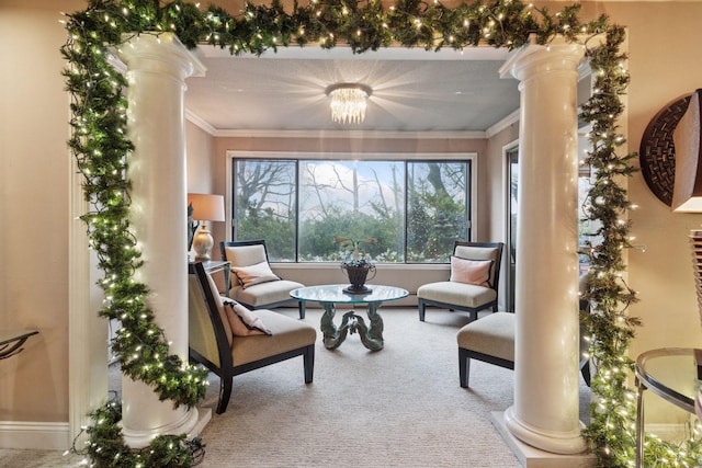 living area featuring ornate columns, carpet, baseboards, and ornamental molding