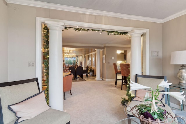 living area featuring decorative columns, ornamental molding, carpet, a chandelier, and baseboards