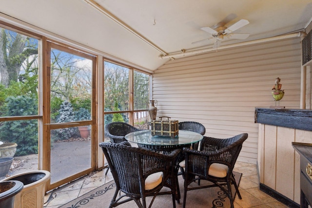 sunroom / solarium featuring ceiling fan, lofted ceiling, and outdoor dining space