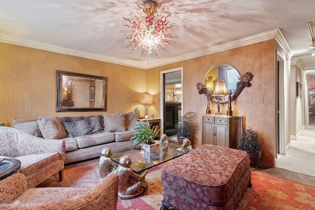 living area featuring a chandelier, ornamental molding, and baseboards