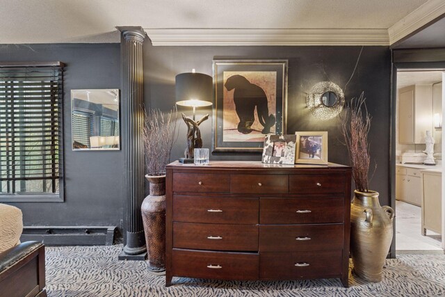 carpeted bedroom with ornamental molding and connected bathroom