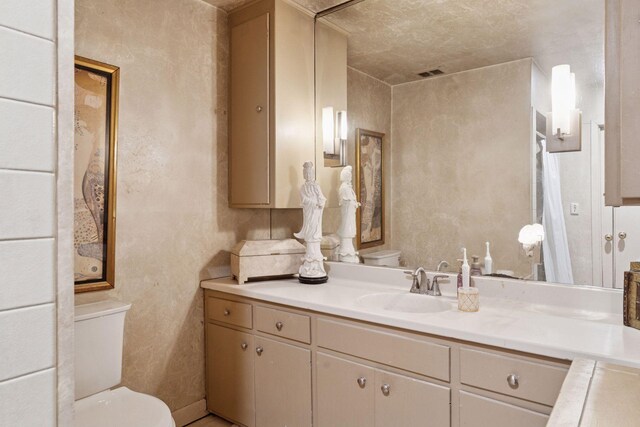 bathroom with toilet and vanity
