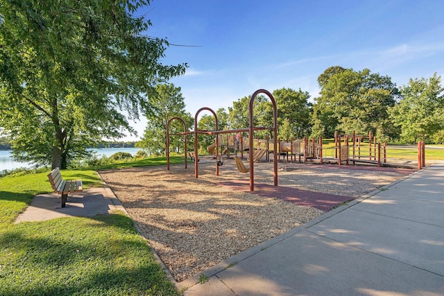 community playground with a water view and a yard