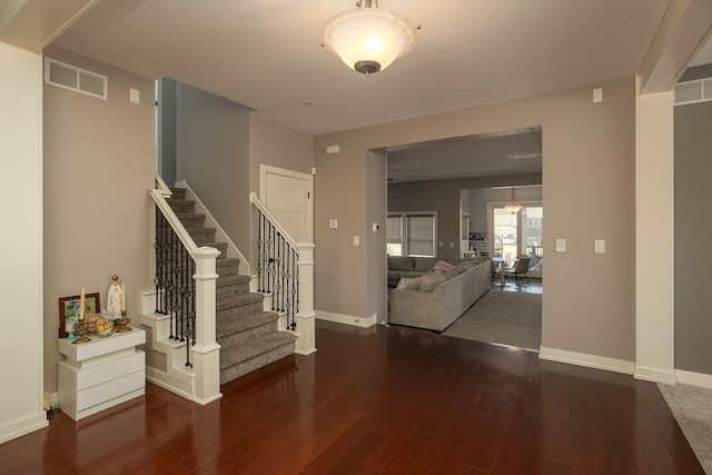 6724 Clarkia Dr NW, Rochester, MN 55901 - entryway with wood finished floors, stairway, and baseboards