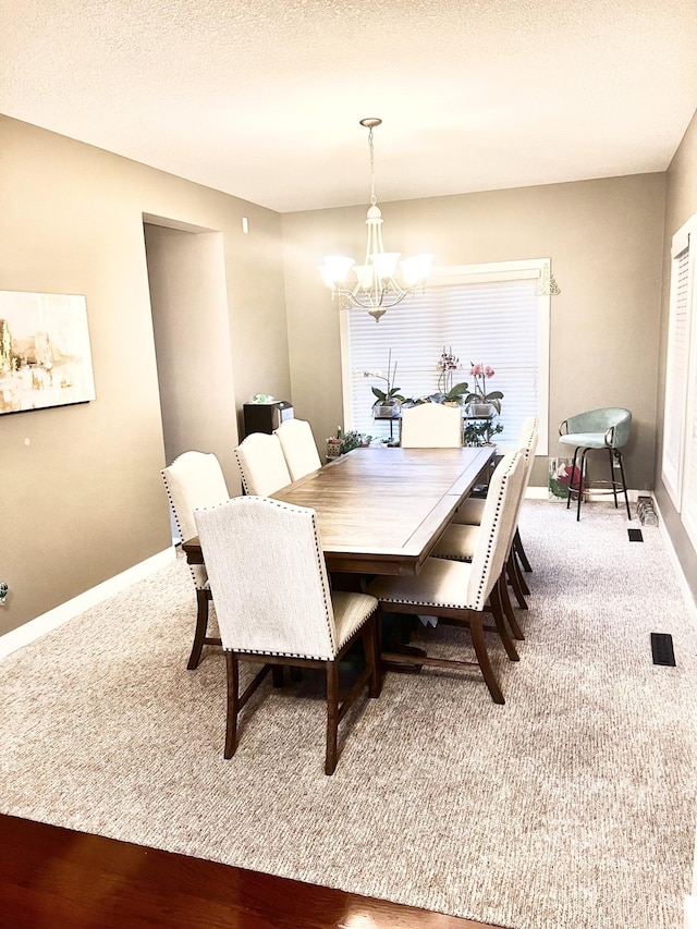 6724 Clarkia Dr NW, Rochester, MN 55901 - carpeted dining area with a chandelier and baseboards