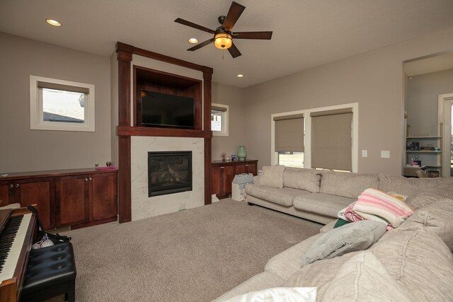 6724 Clarkia Dr NW, Rochester, MN 55901 - carpeted living area featuring ceiling fan, a tiled fireplace, and recessed lighting