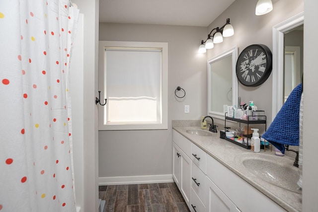 6724 Clarkia Dr NW, Rochester, MN 55901 - full bath with double vanity, wood finished floors, and baseboards