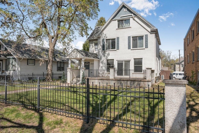 victorian-style house with a fenced front yard and a front yard