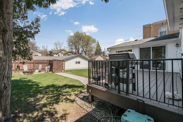 view of yard featuring fence and a wooden deck