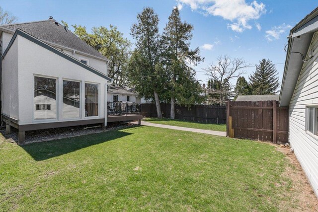 view of yard with a fenced backyard and a wooden deck