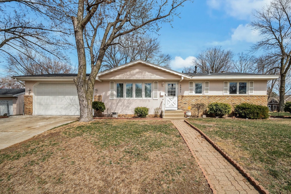3801 Zenith Ave N, Robbinsdale, MN 55422 - ranch-style home with an attached garage, brick siding, a front yard, and concrete driveway