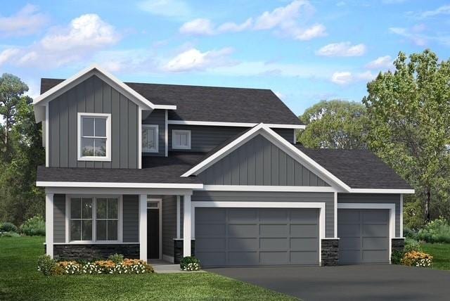 view of front of house featuring a garage, a front lawn, stone siding, board and batten siding, and concrete driveway