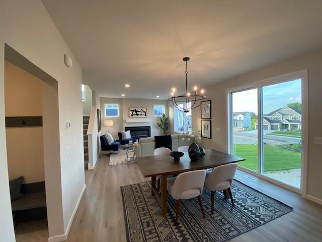 14570 Kingsview Ln N, Dayton, MN 55327 - dining area featuring light wood-style floors, plenty of natural light, a chandelier, and recessed lighting