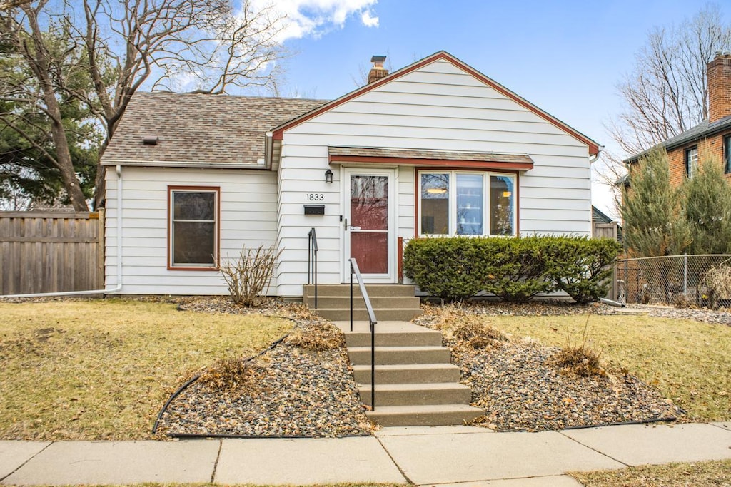 1833 James Ave, Saint Paul, MN 55105 - bungalow-style home featuring a front yard, entry steps, and fence