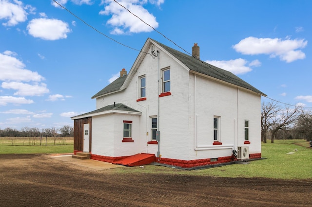 18848 223rd St, Richmond, MN 56368 - view of side of property with a chimney, entry steps, a yard, and brick siding