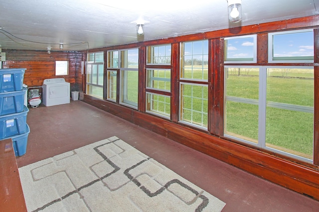 18848 223rd St, Richmond, MN 56368 - unfurnished sunroom featuring concrete flooring, wood walls, and washer / dryer
