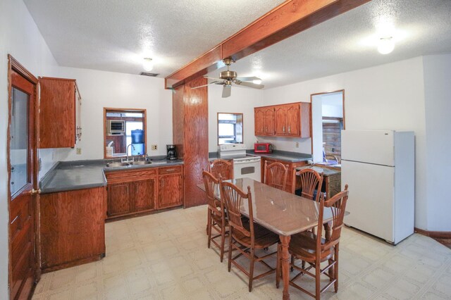 18848 223rd St, Richmond, MN 56368 - kitchen with a sink, white appliances, light floors, and brown cabinets