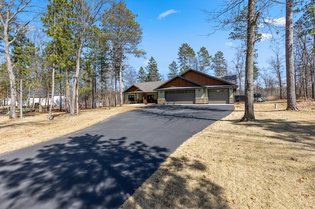 16605 Piper Ln, Brainerd, MN 56401 - craftsman-style house featuring a garage, driveway, stone siding, and a shingled roof