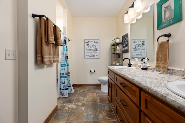 16605 Piper Ln, Brainerd, MN 56401 - full bath featuring baseboards, stone finish flooring, toilet, and double vanity