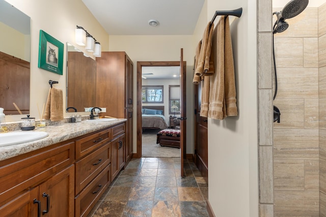 16605 Piper Ln, Brainerd, MN 56401 - full bath featuring stone tile floors, ensuite bath, double vanity, tiled shower, and baseboards