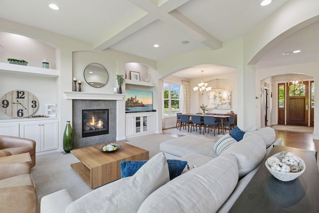 17607 64th Pl N, Maple Grove, MN 55311 - living area featuring arched walkways, beam ceiling, plenty of natural light, a chandelier, and a tile fireplace