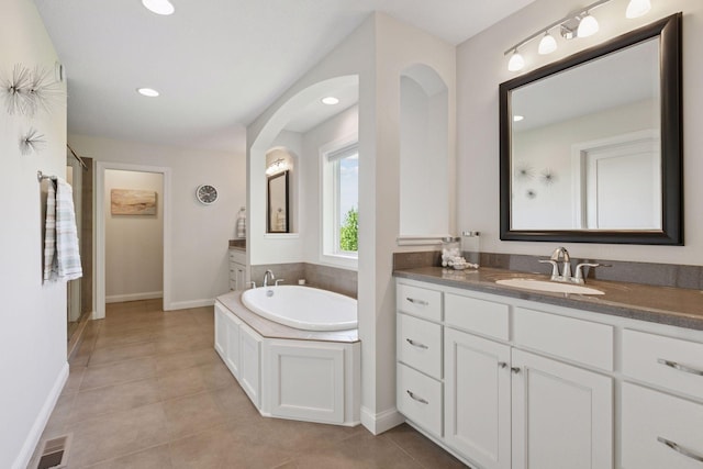 17607 64th Pl N, Maple Grove, MN 55311 - full bathroom with two vanities, a garden tub, a shower stall, tile patterned flooring, and baseboards